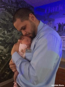 Antonio holding and hugging his youngest baby