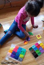 Girl playing with Perler beads