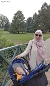 Nida in the park with her baby in a stroller
