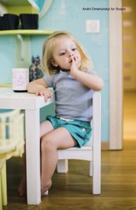 Toddler thinking while sitting on a chair