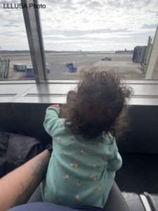 Carmen watching the planes while waiting to be boarded