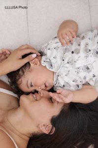 Nicole and her child cuddle face to face